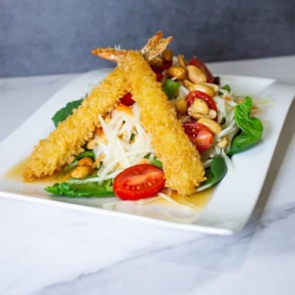 Crispy fried shrimp over a Thai papaya salad with tomatoes, peanuts, and basil.